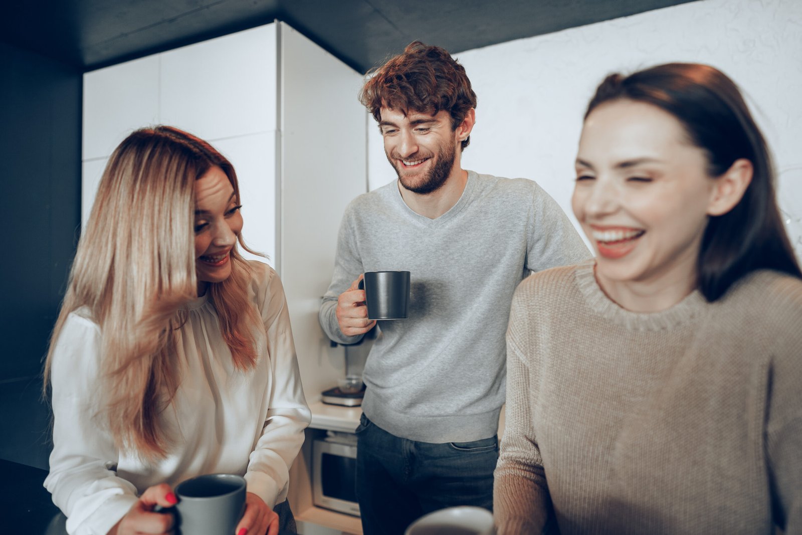 Kolleginnen und Kollegen mit Kaffeebechern in der B&uuml;rokaffeepause